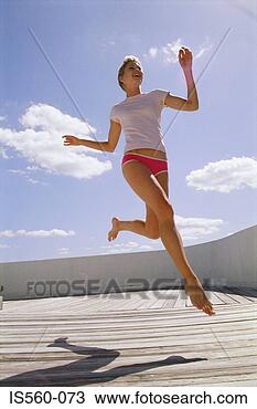 Stock Photo - woman running 
on decking. fotosearch 
- search stock 
photos, pictures, 
images, and photo 
clipart