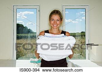 Stock Photo - woman holding 
pile of towels. 
fotosearch - search 
stock photos, 
pictures, images, 
and photo clipart