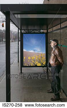 Stock Photo - man standing at 
bus shelter. fotosearch 
- search stock 
photos, pictures, 
images, and photo 
clipart