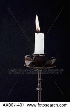 Picture - close-up of a 
burning candle 
on a candlestick 
holder. fotosearch 
- search stock 
photos, pictures, 
images, and photo 
clipart