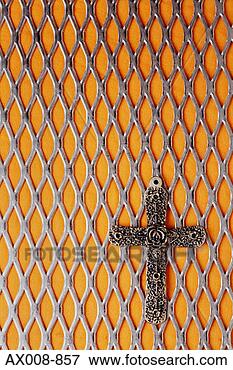 Picture - close-up of a 
crucifix hung 
on a metal grille. 
fotosearch - search 
stock photos, 
pictures, images, 
and photo clipart