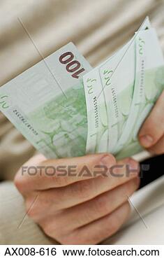 Stock Photo - close-up of a 
person's hands 
holding three 
one hundred euro 
banknotes. fotosearch 
- search stock 
photos, pictures, 
images, and photo 
clipart