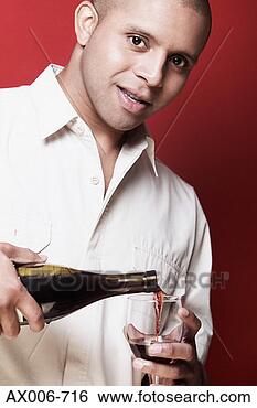 Stock Photo - portrait of a 
young man pouring 
red wine into 
a wine glass. 
fotosearch - search 
stock photos, 
pictures, images, 
and photo clipart