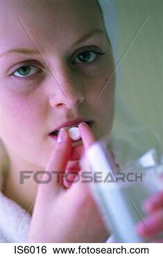 Stock Photo - girl taking tablet. 
fotosearch - search 
stock photos, 
pictures, images, 
and photo clipart