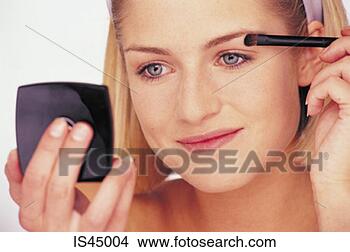 Stock Photo - woman applying 
make-up. fotosearch 
- search stock 
photos, pictures, 
images, and photo 
clipart
