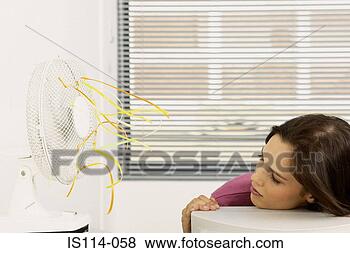 Stock Photo - businesswoman 
cooled by fan 
in office. fotosearch 
- search stock 
photos, pictures, 
images, and photo 
clipart