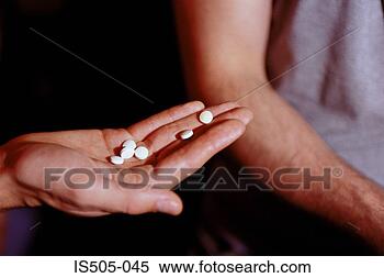 Stock Image - male hand holding 
recreational drugs. 
fotosearch - search 
stock photos, 
pictures, images, 
and photo clipart