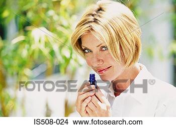 Stock Photo - woman smelling 
scent outdoors. 
fotosearch - search 
stock photos, 
pictures, images, 
and photo clipart