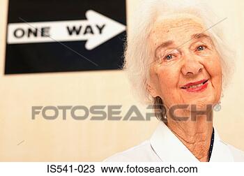 Stock Photo - elderly woman 
with one way sign. 
fotosearch - search 
stock photos, 
pictures, images, 
and photo clipart