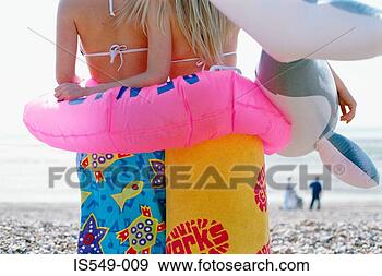 Stock Photograph - girls on the beach 
with inflatable 
lifebelt. fotosearch 
- search stock 
photos, pictures, 
images, and photo 
clipart