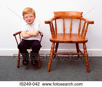 Stock Photo - boy and little 
and large chairs. 
fotosearch - search 
stock photos, 
pictures, images, 
and photo clipart