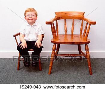 Stock Photo - boy and little 
and large chairs. 
fotosearch - search 
stock photos, 
pictures, images, 
and photo clipart