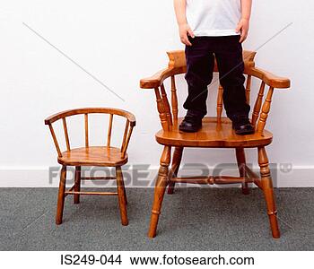 Stock Photo - boy and little 
and large chairs. 
fotosearch - search 
stock photos, 
pictures, images, 
and photo clipart