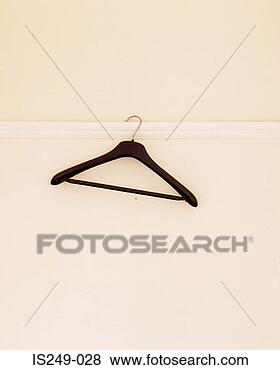 Stock Photo - empty hanger hanging 
on wall. fotosearch 
- search stock 
photos, pictures, 
images, and photo 
clipart