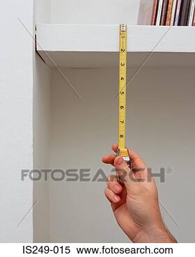 Stock Image - measuring shelf 
height. fotosearch 
- search stock 
photos, pictures, 
images, and photo 
clipart