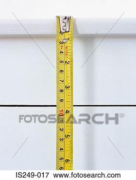 Picture - tape measure being 
used. fotosearch 
- search stock 
photos, pictures, 
images, and photo 
clipart