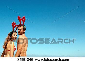 Stock Photo - couple with reindeer 
head decoration. 
fotosearch - search 
stock photos, 
pictures, images, 
and photo clipart