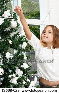 Stock Photo - girl decorating 
christmas tree. 
fotosearch - search 
stock photos, 
pictures, images, 
and photo clipart