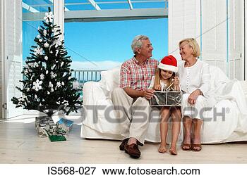 Picture - girl opening her 
christmas present. 
fotosearch - search 
stock photos, 
pictures, images, 
and photo clipart