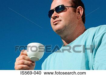 Stock Photography - man holding a 
coffee cup. fotosearch 
- search stock 
photos, pictures, 
images, and photo 
clipart