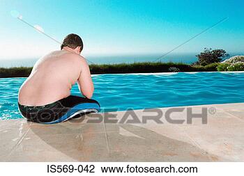 Stock Photo - overweight boy 
having a break 
from swimming. 
fotosearch - search 
stock photos, 
pictures, images, 
and photo clipart