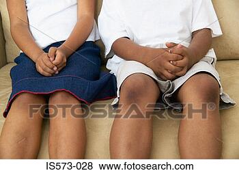 Stock Photo - brother and sister 
on sofa. fotosearch 
- search stock 
photos, pictures, 
images, and photo 
clipart