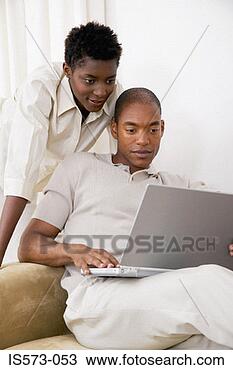 Stock Photo - couple using laptop 
computer. fotosearch 
- search stock 
photos, pictures, 
images, and photo 
clipart