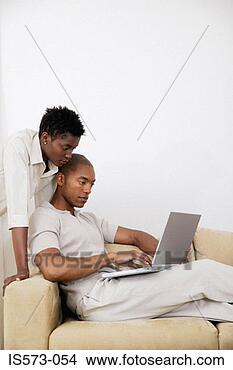 Stock Photo - couple using laptop 
computer. fotosearch 
- search stock 
photos, pictures, 
images, and photo 
clipart