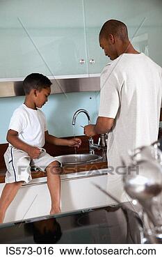 Stock Photo - father and son 
in kitchen. fotosearch 
- search stock 
photos, pictures, 
images, and photo 
clipart