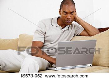 Stock Photo - man using laptop 
computer. fotosearch 
- search stock 
photos, pictures, 
images, and photo 
clipart