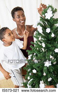 Stock Photography - mother and son 
decorating christmas 
tree. fotosearch 
- search stock 
photos, pictures, 
images, and photo 
clipart
