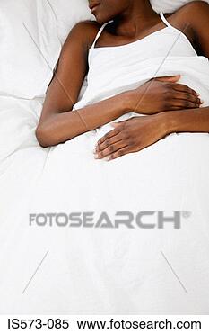 Stock Image - woman resting 
in bed. fotosearch 
- search stock 
photos, pictures, 
images, and photo 
clipart