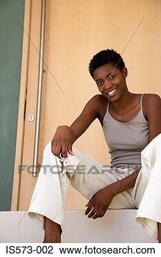 Stock Photo - woman sitting 
on step. fotosearch 
- search stock 
photos, pictures, 
images, and photo 
clipart
