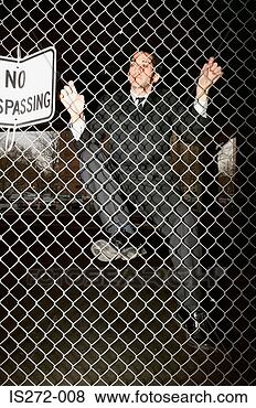 Stock Photo - businessman climbing 
a fence. fotosearch 
- search stock 
photos, pictures, 
images, and photo 
clipart