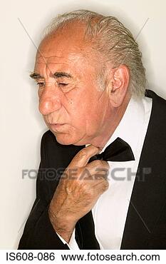 Stock Photo - senior man adjusting 
bow tie. fotosearch 
- search stock 
photos, pictures, 
images, and photo 
clipart