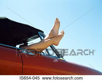 Stock Image - feet sticking 
out of car window. 
fotosearch - search 
stock photos, 
pictures, images, 
and photo clipart