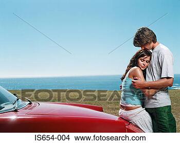 Stock Photo - intimate couple 
by vintage car. 
fotosearch - search 
stock photos, 
pictures, images, 
and photo clipart