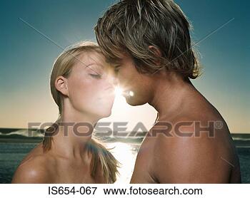 Picture - young couple about 
to kiss at sunset. 
fotosearch - search 
stock photos, 
pictures, images, 
and photo clipart