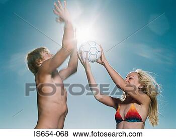 Stock Photo - young man and 
woman playing 
volleyball. fotosearch 
- search stock 
photos, pictures, 
images, and photo 
clipart