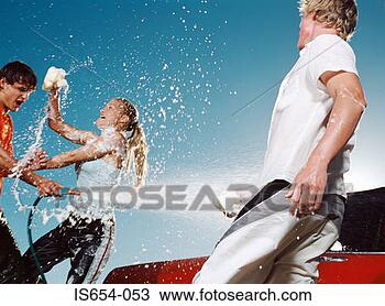 Stock Photo - young people washing 
car and having 
water fight. fotosearch 
- search stock 
photos, pictures, 
images, and photo 
clipart