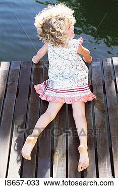 Stock Photo - girl lying on 
a jetty. fotosearch 
- search stock 
photos, pictures, 
images, and photo 
clipart