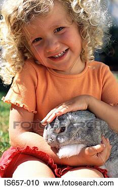 Stock Photography - girl stroking 
a rabbit. fotosearch 
- search stock 
photos, pictures, 
images, and photo 
clipart