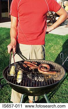 Stock Photography - man cooking food 
on a barbecue. 
fotosearch - search 
stock photos, 
pictures, images, 
and photo clipart