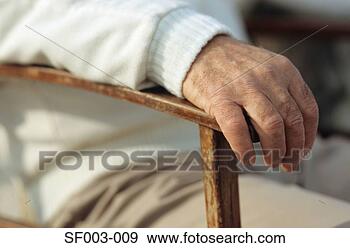 Stock Photograph - man's hand resting 
on chair. fotosearch 
- search stock 
photos, pictures, 
images, and photo 
clipart