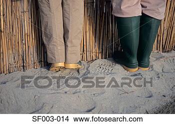 Stock Photo - people in rubber 
boots by fence. 
fotosearch - search 
stock photos, 
pictures, images, 
and photo clipart