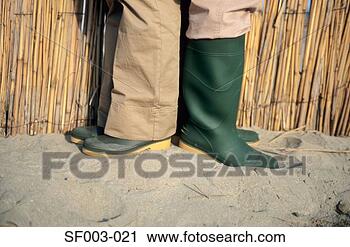Stock Photography - people in rubber 
boots back to 
back. fotosearch 
- search stock 
photos, pictures, 
images, and photo 
clipart