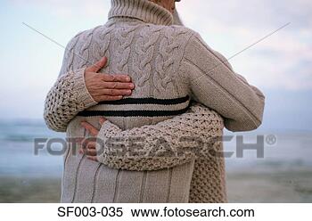 Stock Image - rear view of couple 
hugging on beach. 
fotosearch - search 
stock photos, 
pictures, images, 
and photo clipart