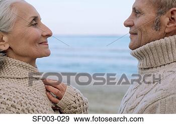 Stock Photograph - senior couple 
face to face on 
the beach. fotosearch 
- search stock 
photos, pictures, 
images, and photo 
clipart