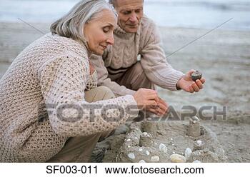 Stock Photography - senior couple 
making a sandcastle. 
fotosearch - search 
stock photos, 
pictures, images, 
and photo clipart