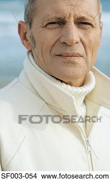 Stock Photo - senior man at 
beach looking 
at camera. fotosearch 
- search stock 
photos, pictures, 
images, and photo 
clipart